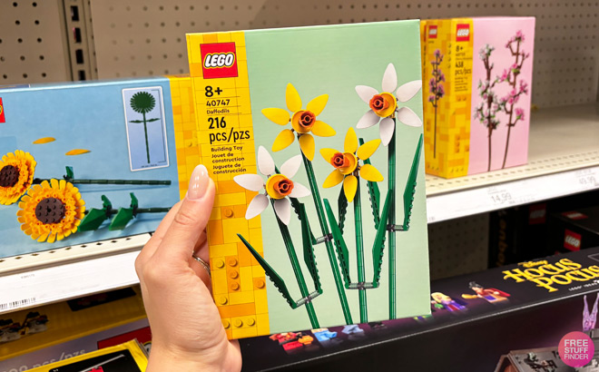 a Hand Holding LEGO Daffodils 216 Piece Set