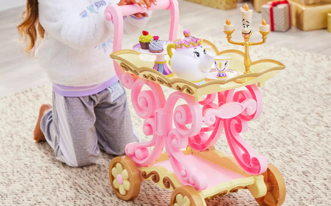 a Kid Playing with a Beauty and the Beast Be Our Guest Singing Tea Cart Play Set