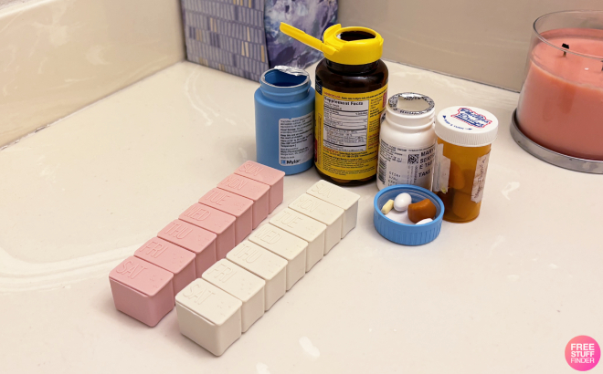 2 Pack Weekly Pill Organizer with Different Medicine on a Marble Table