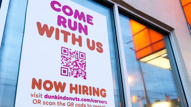 A Dunkin' Donut Window with a Job Hiring Sign