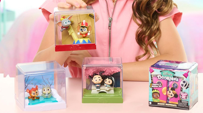 A Girl Holding Disney Doorables Movie Moments Figures Set