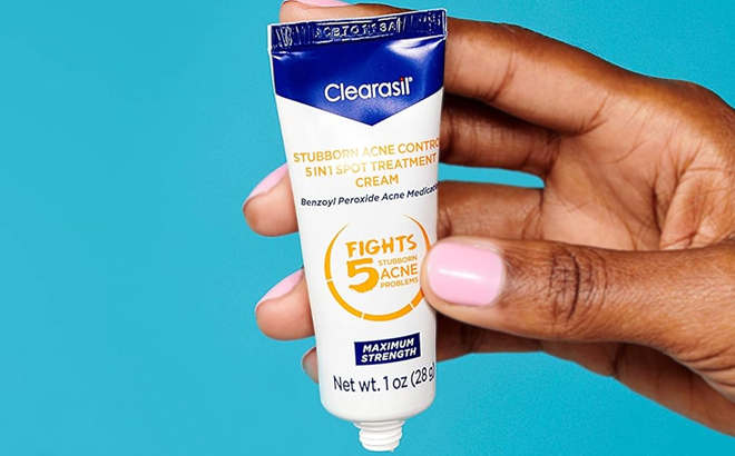 A Hand Holding Clearasil Acne Control Treatment Cream