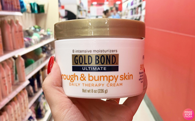 A Hand Holding Gold Bond Rough Bumpy Cream