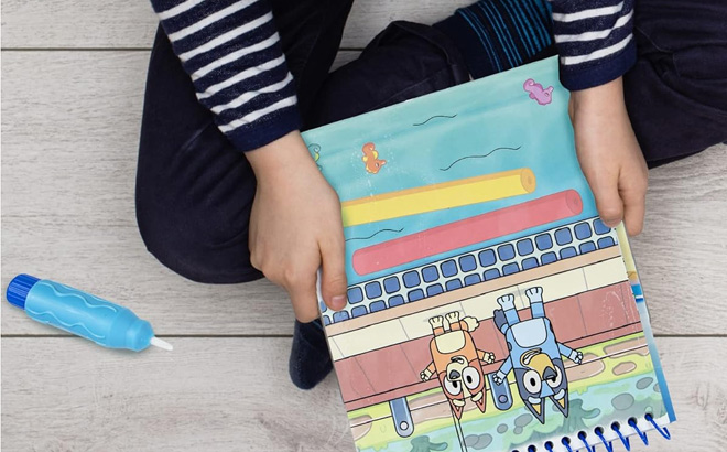 A Kid Holding Bluey Aqua Art