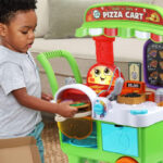 A Little Boy Pretending to Bake a Pizza on his LeapFrog Build a Slice Pizza Cart