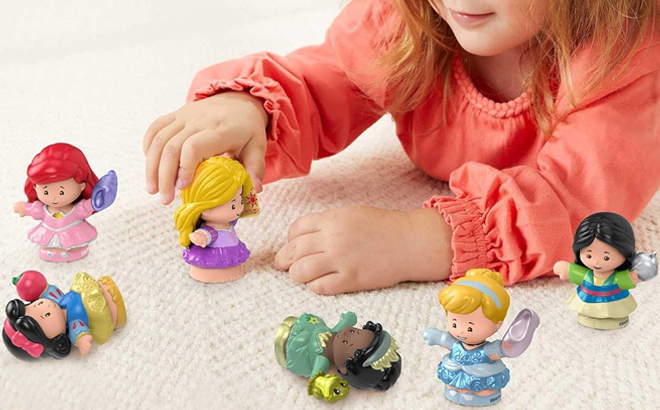 A Little Girl Playing with the Fisher Price Little People Disney Princess 6 Character Figures Set