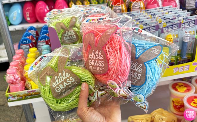 A Perosn Holding Edible Easter Grass Candy Bags in Three Colors