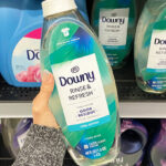 A Person Holding Downy Rinse Refresh Laundry Odor Remover Fabric Softener in Cool Cotton Scent