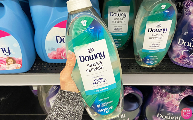 A Person Holding Downy Rinse Refresh Laundry Odor Remover Fabric Softener in Cool Cotton Scent