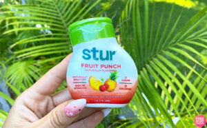 A Person Holding Stur Fruit Punch Water Enhancer