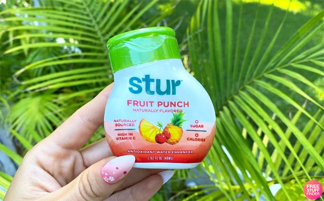 A Person Holding Stur Fruit Punch Water Enhancer