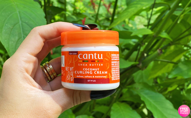 A Person Holding a Jar of Cantu Coconut Curling Cream