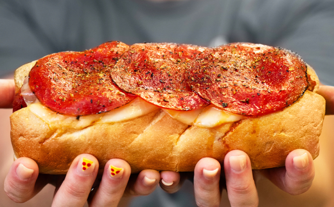 A Person Holding a Pepperoni Pizza Firehouse Sub