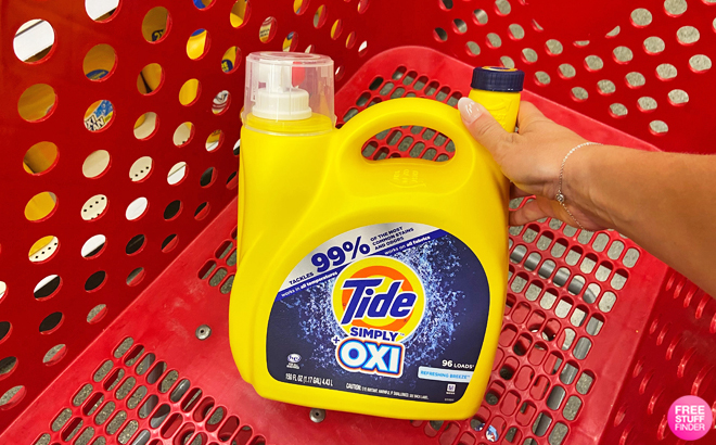 A Person Holding a Tide Simply Oxi Liquid Laundry Detergent on a Cart