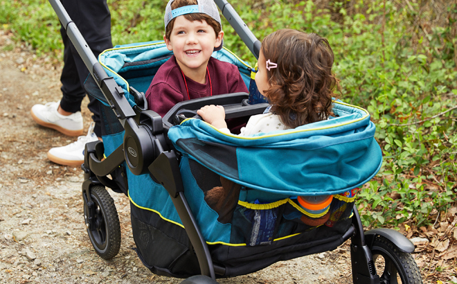 A Person Pulling Kids in a Graco Modes Adventure Wagon Stroller