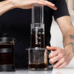 A Person Using the AeroPress Tinted 3 in 1 Brewing Coffee Press