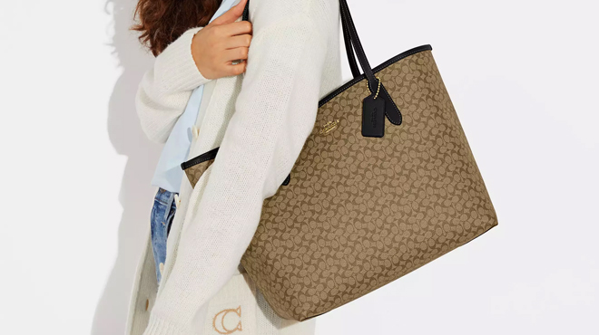 A Person Wearing Beige Coach Tote Bag