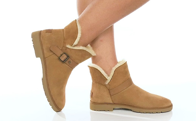A Person Wearing UGG Romely Short Buckle Boots in the Color Chestnut