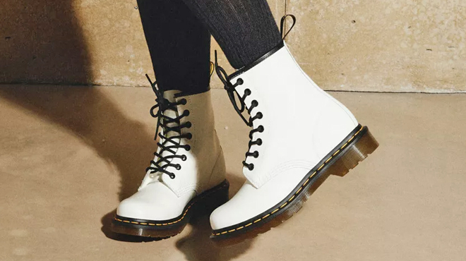A Person Wearing a Pair of Dr Martens Lace Up Boots