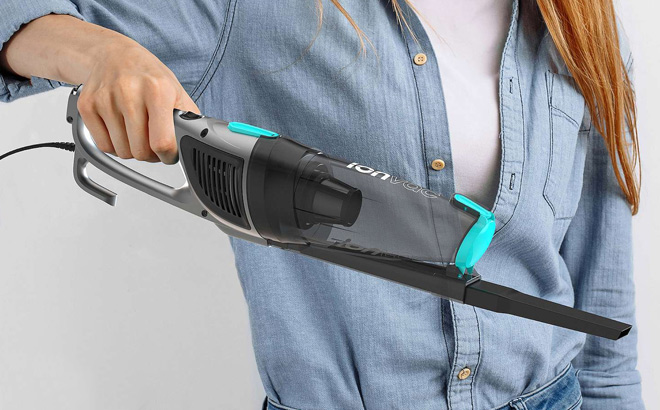 A Person is Holding Tzumi Upright Dry Zip Vacuum