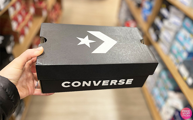 A Person is Holding a Box With Converse Shoes