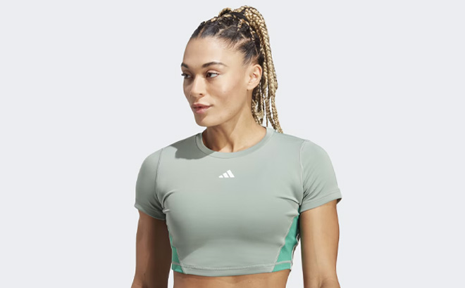 A Person is Wearing Adidas Womens Training Colorblock Crop Top in Silver Green Color