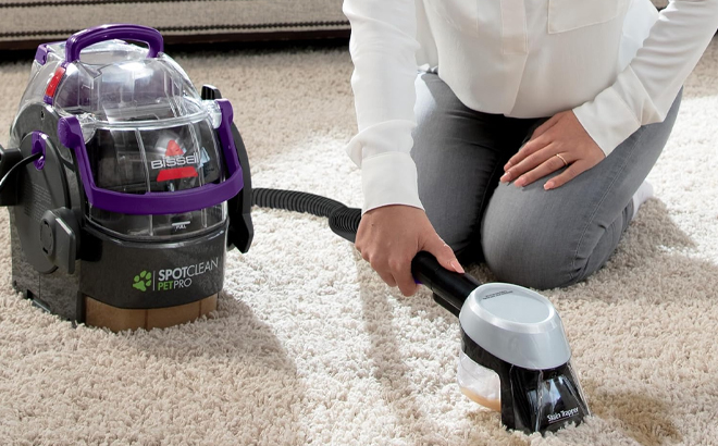 A Woman Cleaning the Carpet with Bissell SpotClean Pet Pro Portable Carpet Cleaner