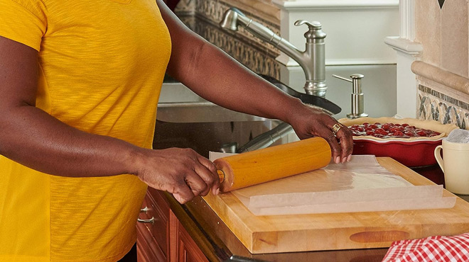 A lady using a Reynolds Cut Rite Wax Paper in the Kitchen A lady using a Reynolds Cut Rite Wax Paper in the Kitchen