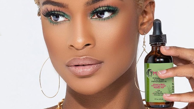 A person Holding the Mielle Organics Rosemary Mint Scalp Hair Strengthening Oil A person Holding the Mielle Organics Rosemary Mint Scalp Hair Strengthening Oil