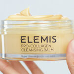 A person holding an ELEMIS Pro Collagen Cleansing Balm