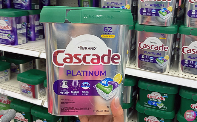 A photo of a hand holding a Cascade Platinum Dishwasher Pods