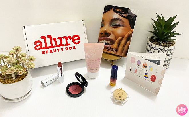 Allure Beauty Box next to Beauty Products and Plants on a Tabletop