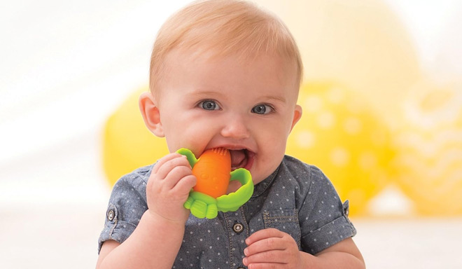 Baby Holding Orange Carot Textured Silicone Baby Teether