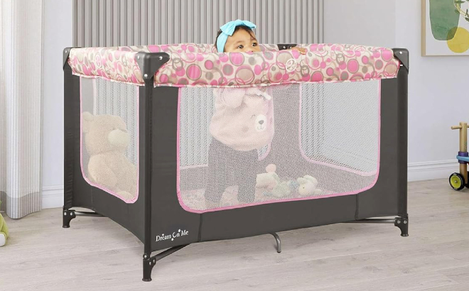 Baby in a Dream On Me Zodiak Portable Playard
