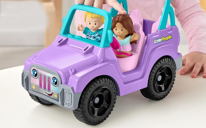 Girl Playing with the Fisher Price Little People Barbie Beach Cruiser with Figures Set Girl Playing with the Fisher Price Little People Barbie Beach Cruiser with Figures Set