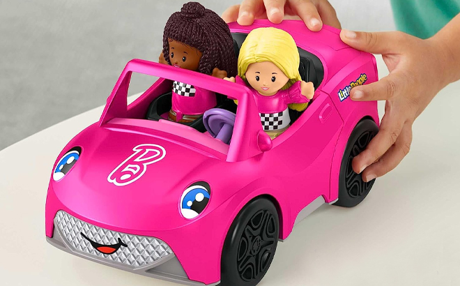 Girl Playing with the Fisher Price Little People Barbie Convertible with Figures Set