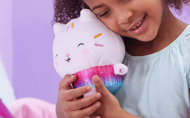 Girl is Holding Spin Master Gabbys Dollhouse Cakey Cat Purr ific Plush Toy
