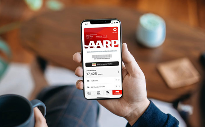 Hand Holding a Phone with AARP Membership on the Background