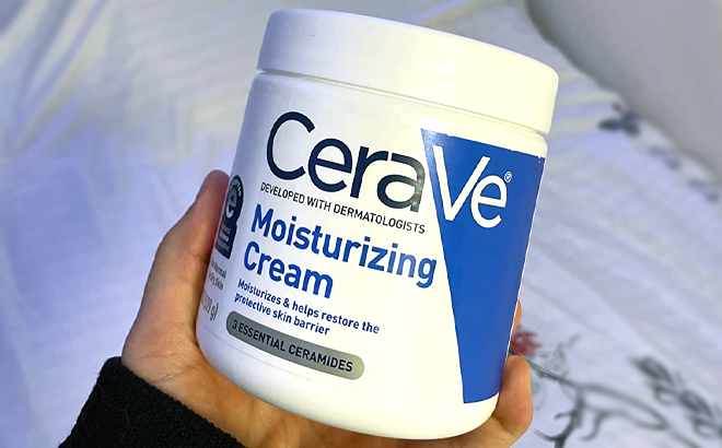 Hand holding CeraVe Moisturizing Cream