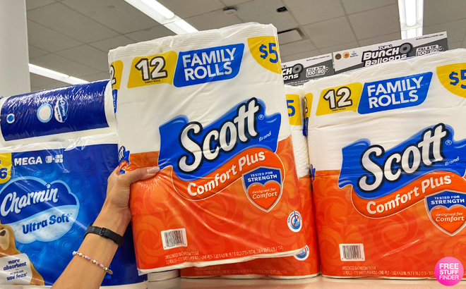 Hand holding Scott ComfortPlus Toilet Paper