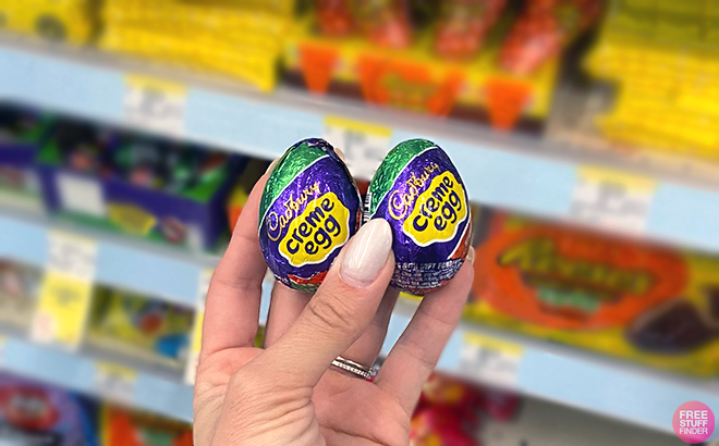 Hand holding two Cadbury Egg Milk Chocolate Easter Candies