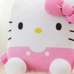 Hello Kitty Kids Squishy 15 Inch Pillow Sitting on a Fluffy Throw