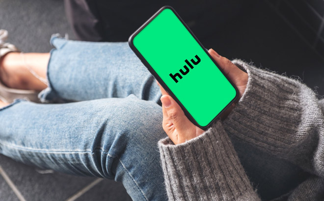 Girl Holding a Phone with Hulu and Disney+ Bundle on the Background
