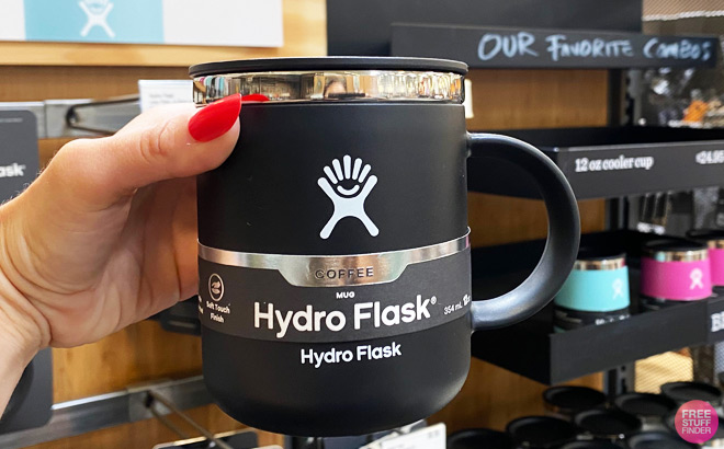 Hand Holding a Black Hydro Flask Coffee Mug at a Store