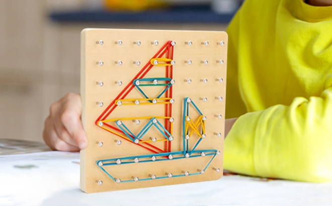 Kid holding the Wooden Geoboard