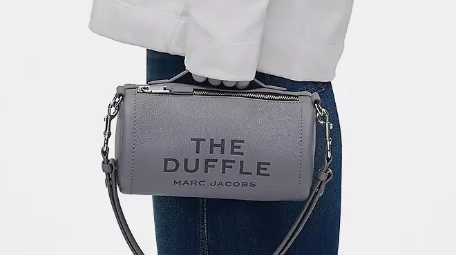 A Closeup of Marc Jacobs The Leather Duffle Bag Being Carried in a Person's Hand