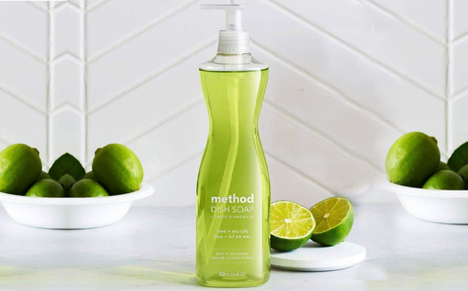 Method Dish Soap Lime Sea Salt Scent Biodegradable Formula on a Kitchen Counter with Limes in the Background