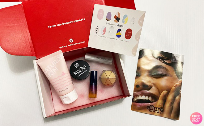 Opened Beauty Box with Products on the Inside next to a Magazine