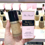 Person Holding Too Faced Born This Way Foundation at a Store