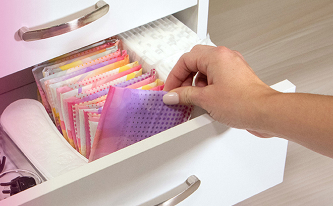 Person Picking Up a U by Kotex Balance Daily Wrapped Panty Liner from a Drawer Person Picking Up a U by Kotex Balance Daily Wrapped Panty Liner from a Drawer